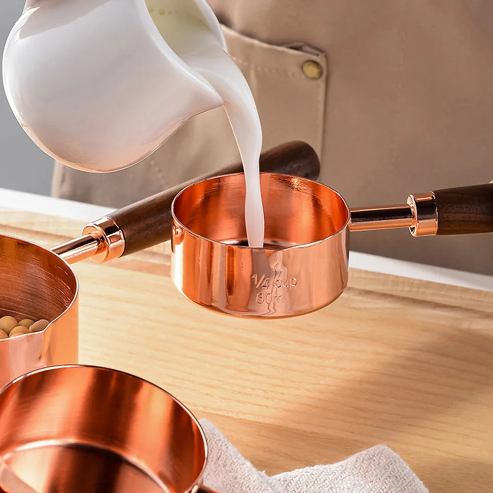 Stainless measuring cups with a wooden handle in a set